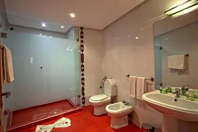 a bathroom with a toilet and a sink and a shower at Yaad City Hotel in Marrakech