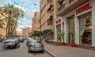 a street with cars parked in front of buildings at Yaad City Hotel in Marrakech
