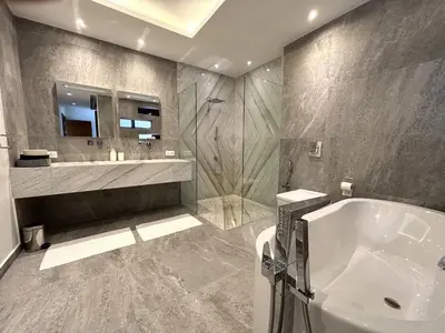 a bathroom with a tub and a sink and a mirror at Palais Kahli in Marrakech