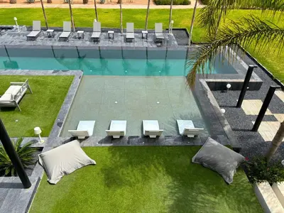 an overhead view of a pool with tables and benches at Palais Kahli in Marrakech