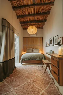 a bedroom with a bed and a wooden ceiling at Riad Dar M in Marrakech