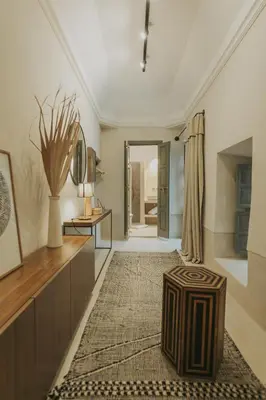 a large living room with a table and a rug at Riad Dar M in Marrakech