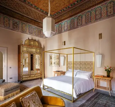 a bedroom with a canopy bed and a couch at Riad Dar Al Dall - This Time Tomorrow in Marrakech in Marrakech