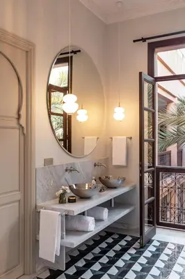 a bathroom with two sinks and a mirror at Riad Dar Al Dall - This Time Tomorrow in Marrakech in Marrakech