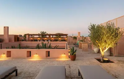 a rooftop patio with a restaurant on a building at Riad Dar Al Dall - This Time Tomorrow in Marrakech in Marrakech