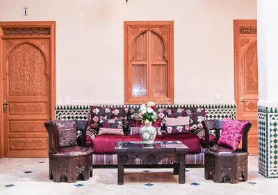 a living room with a couch and two chairs and a table at Riad Des Nations in Marrakech