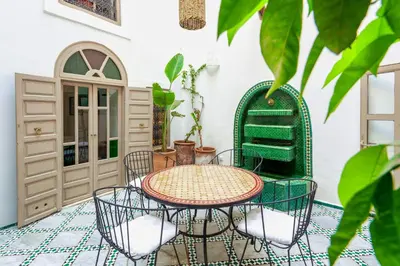 a patio with a table and chairs at Riad Kiwi - Private Historic Riad Jacuzzi & Hammam - Entire Home in Marrakech