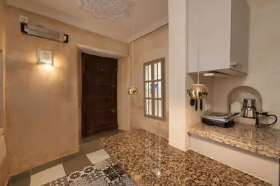 a kitchen with a counter top and a door at Riad Kiwi - Private Historic Riad Jacuzzi & Hammam - Entire Home in Marrakech