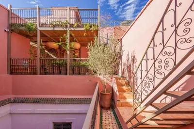 a staircase in a house with potted plants at Riad Kiwi - Private Historic Riad Jacuzzi & Hammam - Entire Home in Marrakech