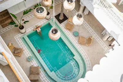 an overhead view of a woman standing in a swimming pool at Riad Zayn & Spa in Marrakech