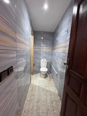 a bathroom with a toilet and a glass door at Riad Dar Zarbia in Marrakech