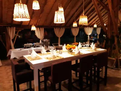 a large white table with chairs and chandeliers at THE FARM LODGES & Private pool in Marrakech