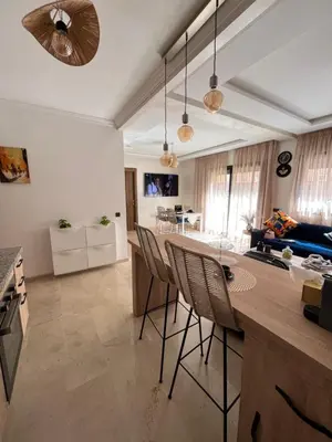 a kitchen with chairs and a table in a room at Charming Appartment in Gueliz in Marrakech