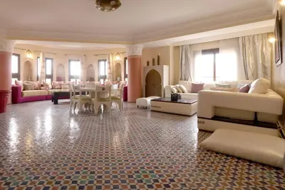 a large living room with couches and tables at Typical large central appt in Gueliz with nice view in Marrakech