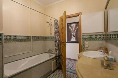 a bathroom with a tub and a sink and a bath tub at Typical large central appt in Gueliz with nice view in Marrakech
