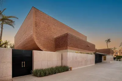 a red brick building with a black door at Golden Skyline – Marrakech in Marrakech