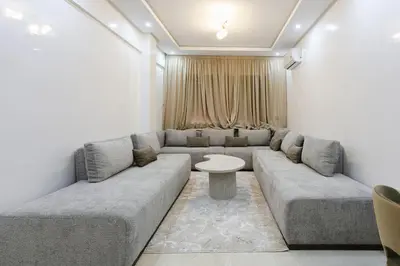 a living room with a couch and a table at Golden Skyline – Marrakech in Marrakech