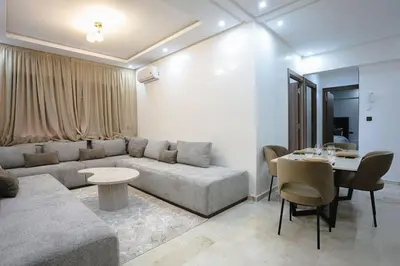 a living room with a couch and a table at Golden Skyline – Marrakech in Marrakech