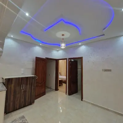 a blue light on a ceiling in a room at Bel appartement de 2 chambres L in Marrakech