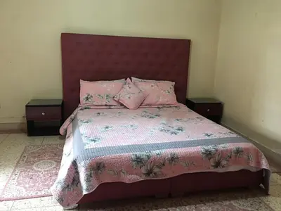 a bedroom with a pink bed with two night stands at Riad sofia in Marrakech