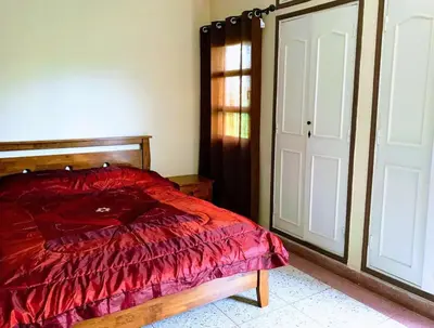 a bedroom with a red bed and a door at Riad sofia in Marrakech