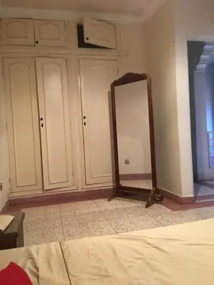 a mirror in a room with white cabinets at Riad sofia in Marrakech