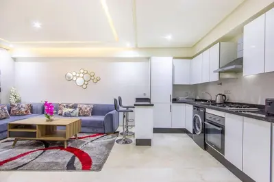 a kitchen and living room with a couch and a table at NEW! Plein Gueliz, wifi, terrasse in Marrakech