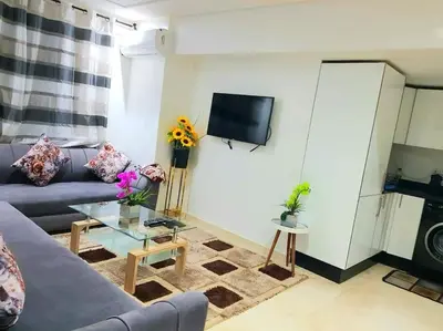 a living room with a couch and a tv at New! Appartement en plein centre ville in Marrakech