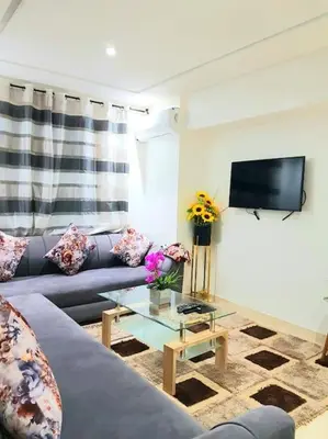 a living room with a couch and a table at New! Appartement en plein centre ville in Marrakech
