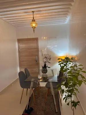 a dining room with a table and a plant at Majorel Blue in Marrakech