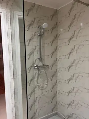a shower with a white marble wall at Majorel Blue in Marrakech
