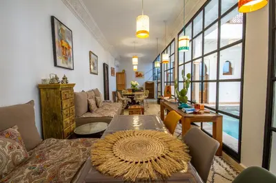 a living room with a couch and a table at Riad Bab Aljana in Marrakech