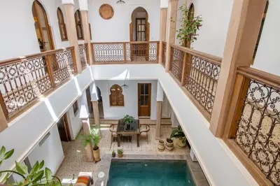 an indoor staircase with a pool in a house at Riad Bab Aljana in Marrakech