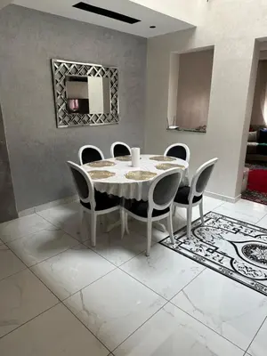 a dining room with a white table and chairs at Riad Jad - Sweet Duplex Appartement in Marrakech