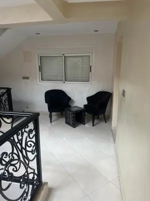 a living room with two chairs and a window at Riad Jad - Sweet Duplex Appartement in Marrakech