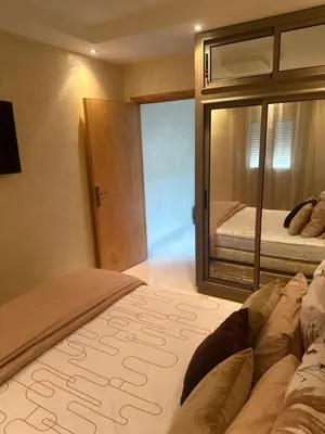 a bedroom with a large bed and a glass door at Riad Jad - Sweet Duplex Appartement in Marrakech