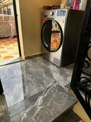 a washing machine sitting in a kitchen with a door open at Riad Jad - Sweet Duplex Appartement in Marrakech