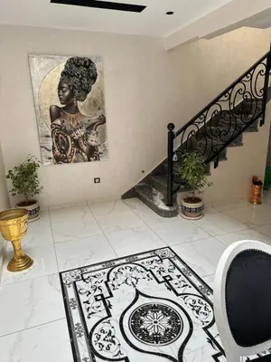 a staircase with a picture of a woman on the wall at Riad Jad - Sweet Duplex Appartement in Marrakech
