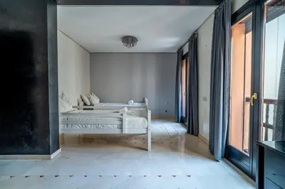 a bedroom with two beds and a window at Appartement Haut standing Gueliz Plaza in Marrakech