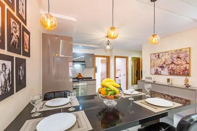 a kitchen with a dining table with glasses and bananas on it at Charmante Wohnung im Herzen von Marrakesch Gueliz in Marrakech