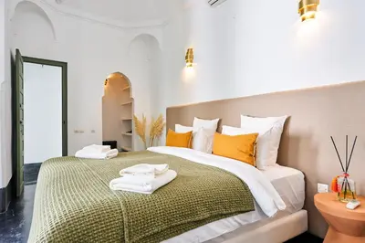 a bedroom with a large bed with towels on it at Riad Dar Nakous in Marrakech