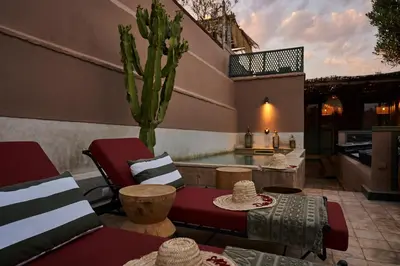 a patio with a table and a cactus in a kitchen at Riad Dar Nakous in Marrakech