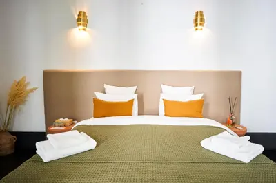 a bedroom with a large bed with orange pillows at Riad Dar Nakous in Marrakech