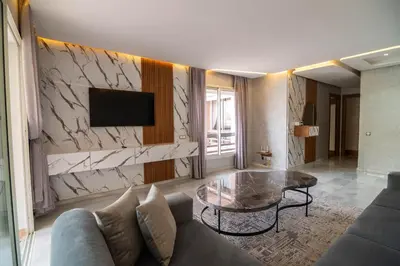 a living room with a couch and a table at Riad Gardens Two Bedroom Apartment in Marrakech