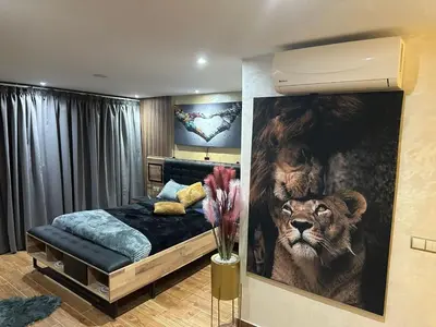 a bedroom with a large painting of a lion at Appartement Luxueux au Rooftop à Guéliz in Marrakech