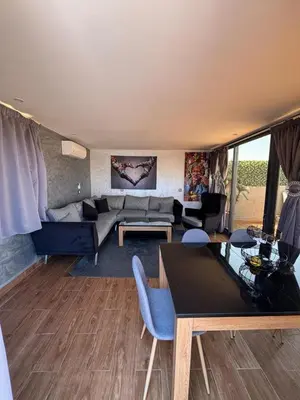 a living room with a couch and a table at Appartement Luxueux au Rooftop à Guéliz in Marrakech