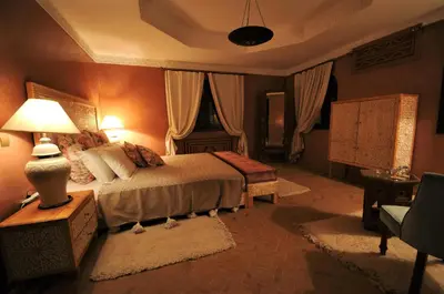 a bedroom with a bed and a lamp on a table at Villa Malika Silvana in Marrakech