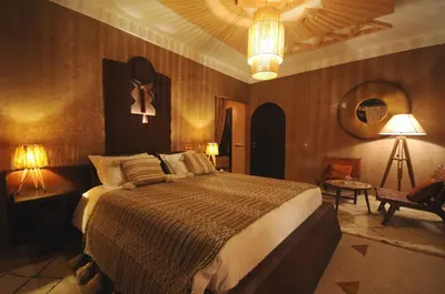 a bedroom with a large bed and two lamps at Villa Malika Silvana in Marrakech
