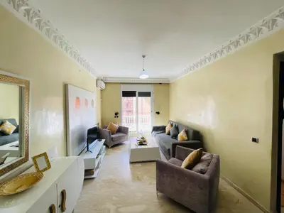 a living room with couches and a tv at Joli appartement Gueliz centre ville in Marrakech