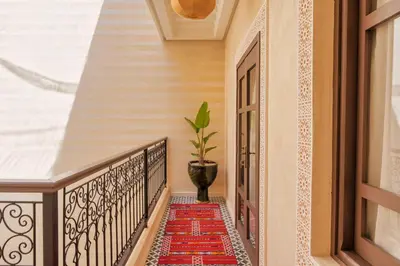 a stairway with a red rug on a balcony at Riad Dar Arwa in Marrakech